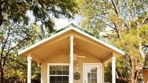 A small, single-story building with a porch, a door, and a window. - Old Irish Inn (Denton)