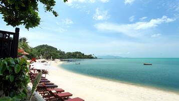 On the beach, sun loungers, beach umbrellas, beach towels