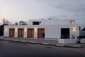 A modern two-story building with a flat roof, large windows, and a white facade. - Evita Elite (Rhodes)