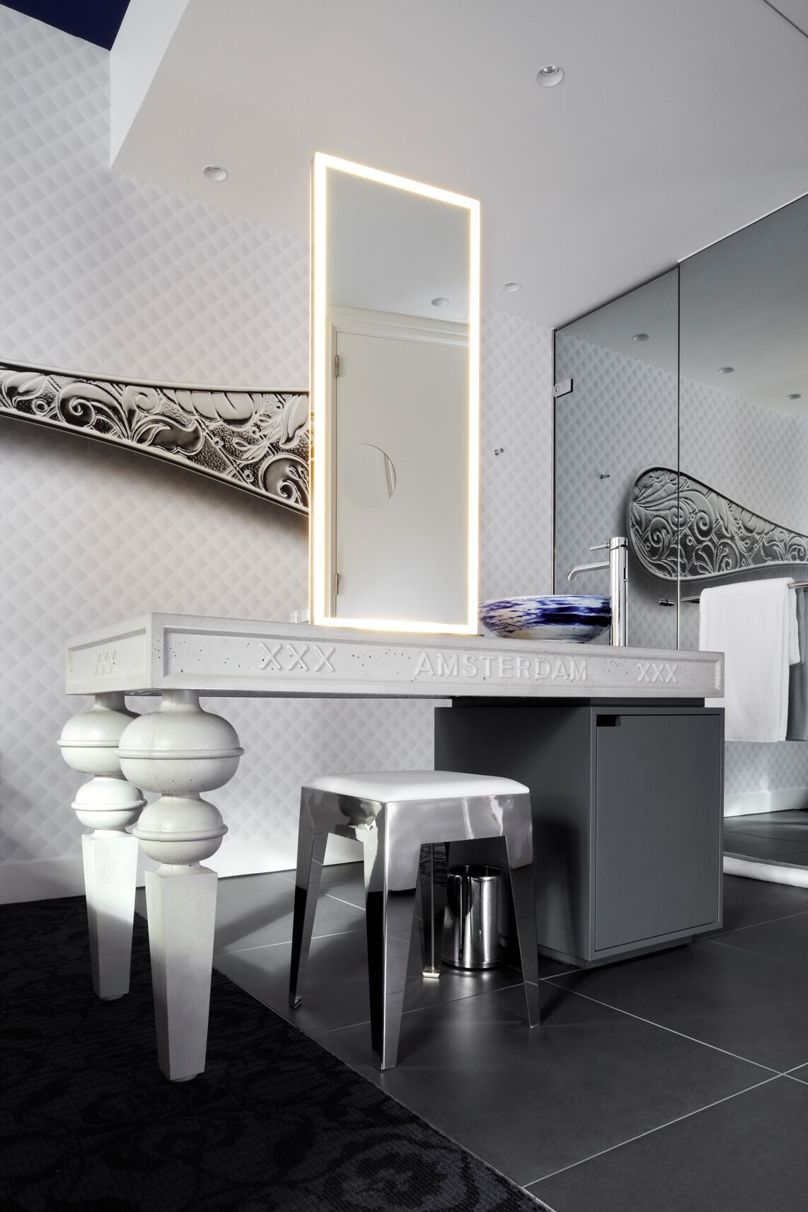 A modern bathroom with a vanity, a large mirror, and a toilet.