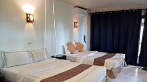 A hotel room with two beds, a nightstand, a wall-mounted lamp, and a curtain. - Faye Orchid Resort (Ko Chang)