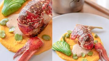 A lobster dish with green peas and a creamy sauce on a plate.