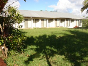 A single-story building with a flat roof and a long, narrow structure with multiple windows.