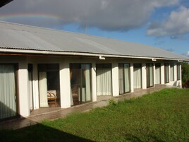 A single-story building with a flat roof, large windows, and a covered porch area.