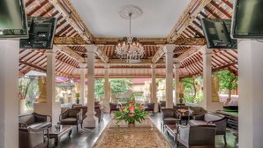 A spacious lobby with a marble floor, elegant furniture, and a central floral arrangement. - Bounty Hotel (Kuta)
