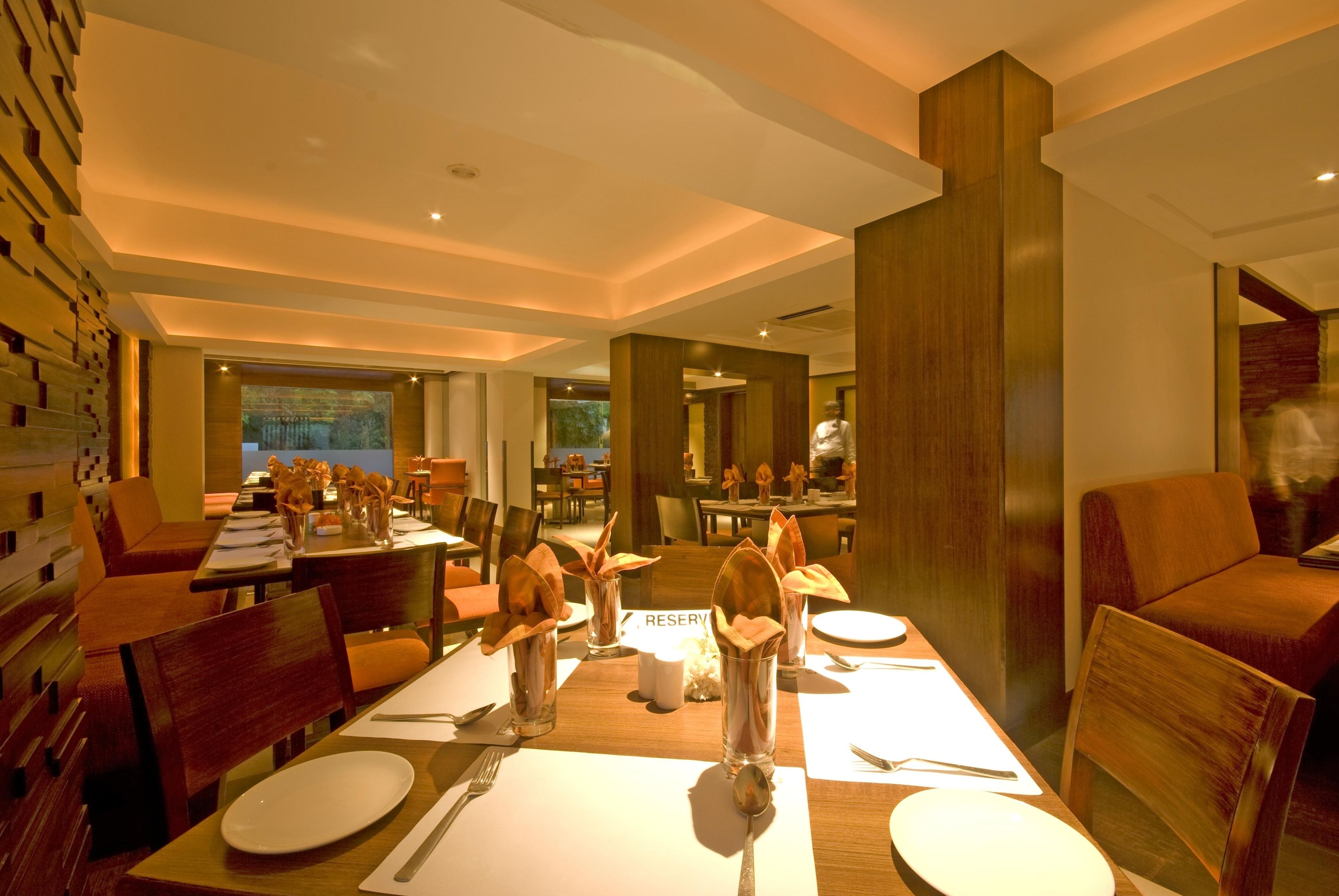 A dining area with tables set for service, a 'RESERVE' sign, and a view of the outdoors.