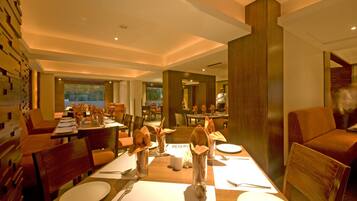 A dining area with tables set for service, a 'RESERVE' sign, and a view of the outdoors.