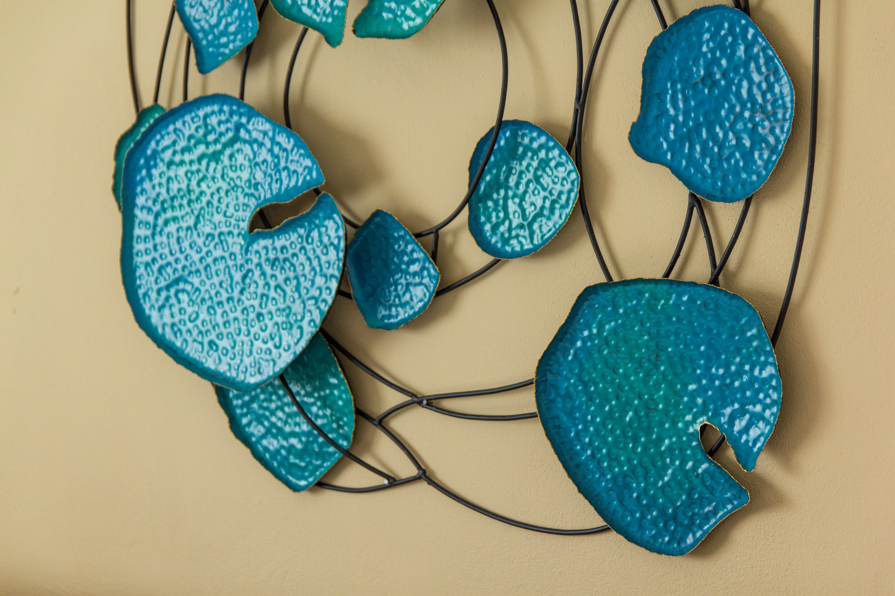 A decorative wall piece with abstract shapes and a neutral background.