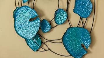 A decorative wall piece with abstract shapes and a neutral background.