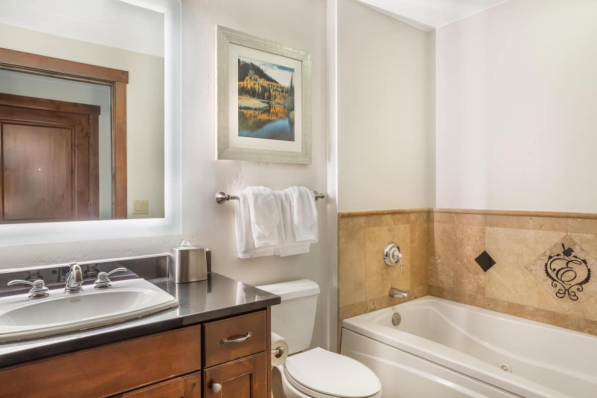 A bathroom with a sink, toilet, and bathtub.