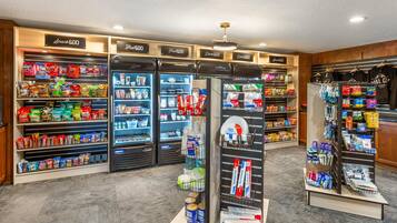 A snack and drink kiosk area with refrigerated sections and a display of branded merchandise.