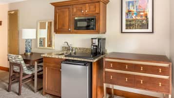 A compact kitchen with a microwave, coffee maker, and dishwasher.