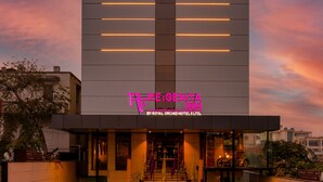 A hotel with a modern architectural design, featuring a prominent entrance with steps leading up to the main doors. - Regenta Inn Jaipur (Jaipur)