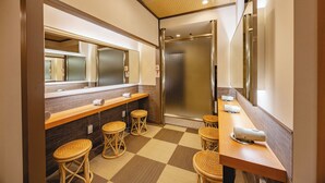 A hotel bathroom with a checkered floor, a mirror, a sink, and a shower stall. - Nagoya Crown Hotel (Nagoya)
