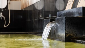A water feature with a waterfall in a tiled area. - Nagoya Crown Hotel (Nagoya)