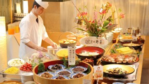 A buffet with various dishes and a chef serving food. - Nagoya Crown Hotel (Nagoya)