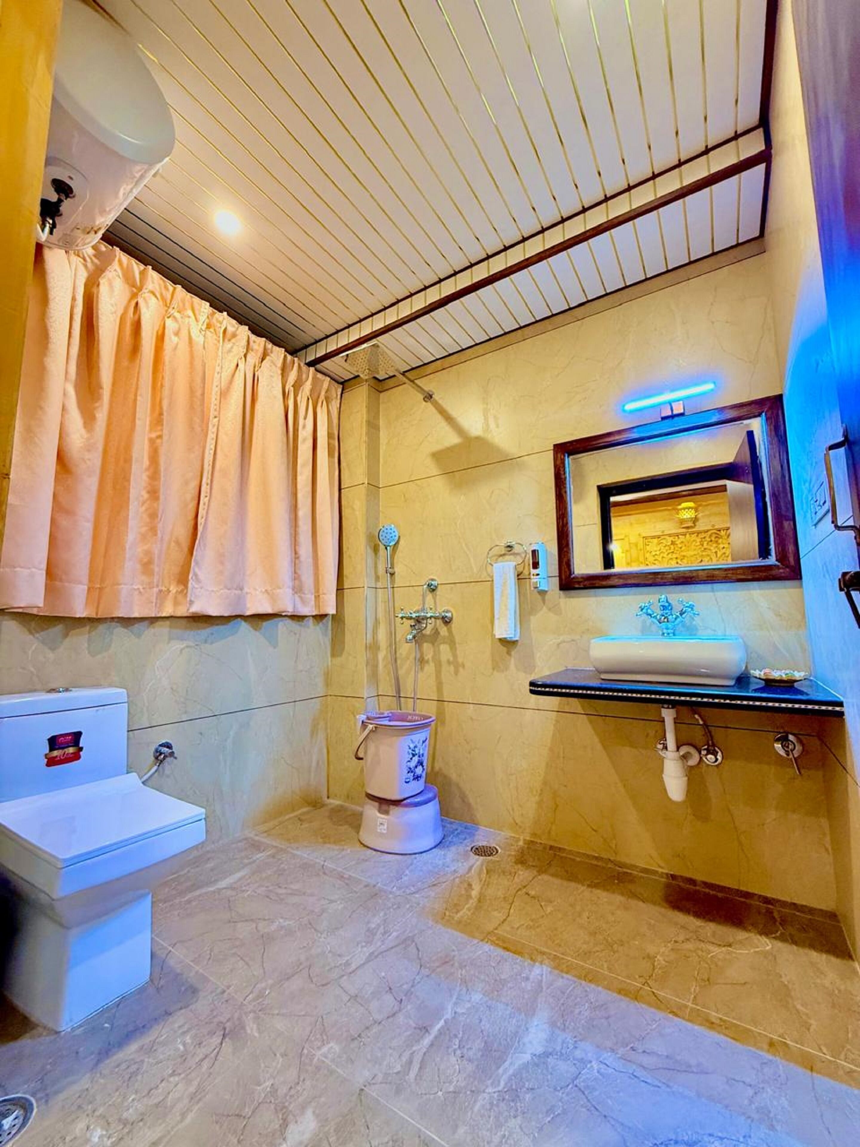 A bathroom with a toilet, sink, and shower.