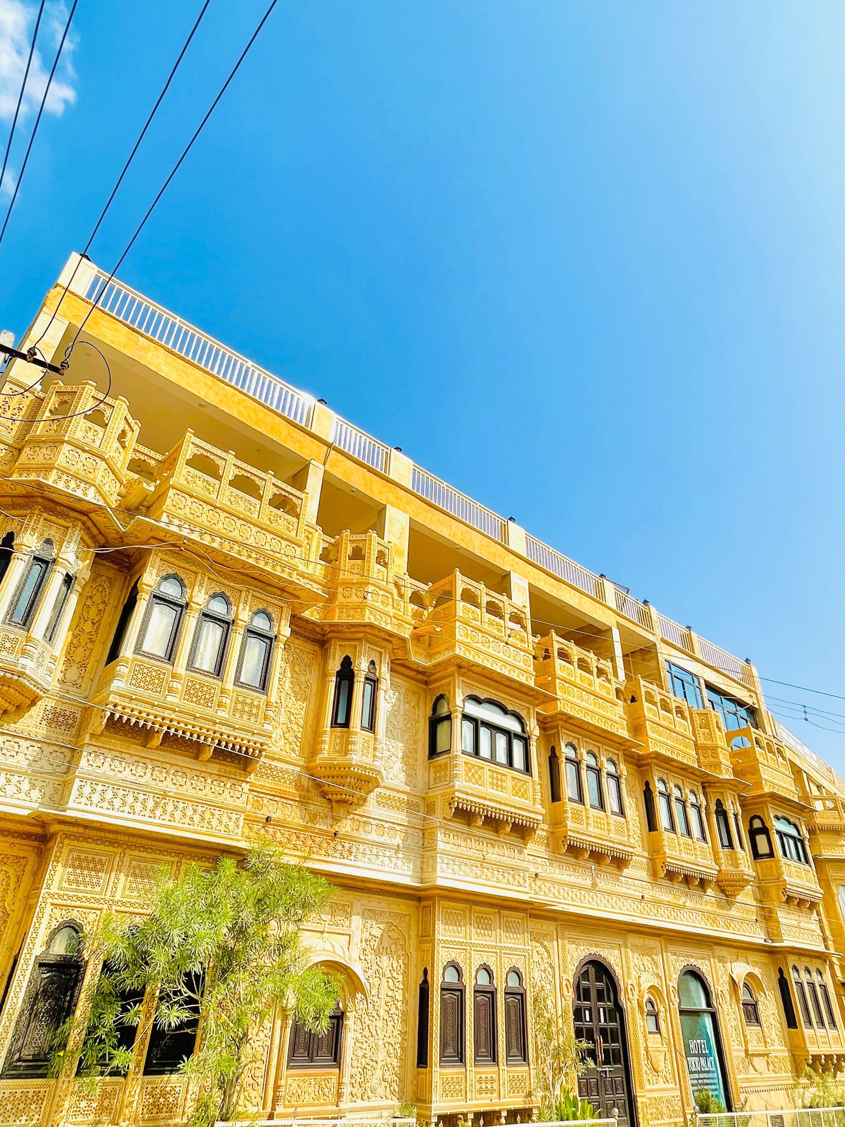 A multi-story building with ornate architectural details, including carved balconies and arched windows.