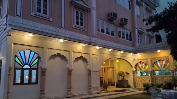 A building with a traditional architectural style, featuring arched doorways and decorative window frames.