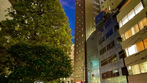 A multi-story building with a sign reading "APA" at the top. - APA Hotel Mita Ekimae (Tokyo)