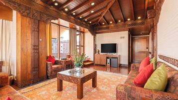 Newari Presidential Suite | Living area | 55-inch flat-screen TV with cable channels