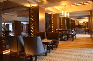 A hotel lobby with seating areas, a reception desk, and a patterned carpet. - Hotel Yak & Yeti (Kathmandu)