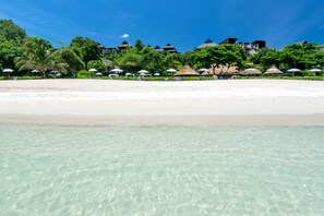 On the beach, white sand, beach umbrellas, beach towels