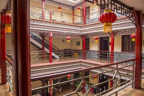 Een meerlaags gebouw met een traditioneel ontwerp, met balkons en hekwerken.