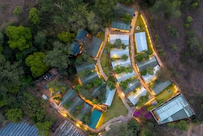 An aerial view of a resort with multiple rectangular buildings, a swimming pool, and surrounding greenery. - Orchid Hotel Panchgani (Mahabaleshwar)