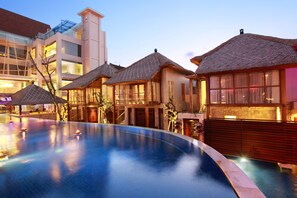 Experience a unique blend of traditional and modern design in this serene hotel setting, featuring a well-maintained pool.