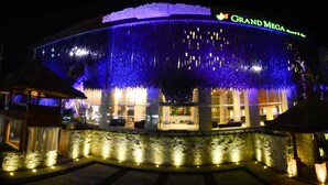 A hotel with a large, illuminated facade and a sign reading "GRAND MEGA Resort & Spa". - Grand Mega Resort & Spa Bali (Kuta)