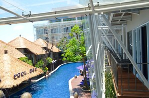 Relax by the pool surrounded by a serene atmosphere and enjoy refreshments at the adjacent bar.