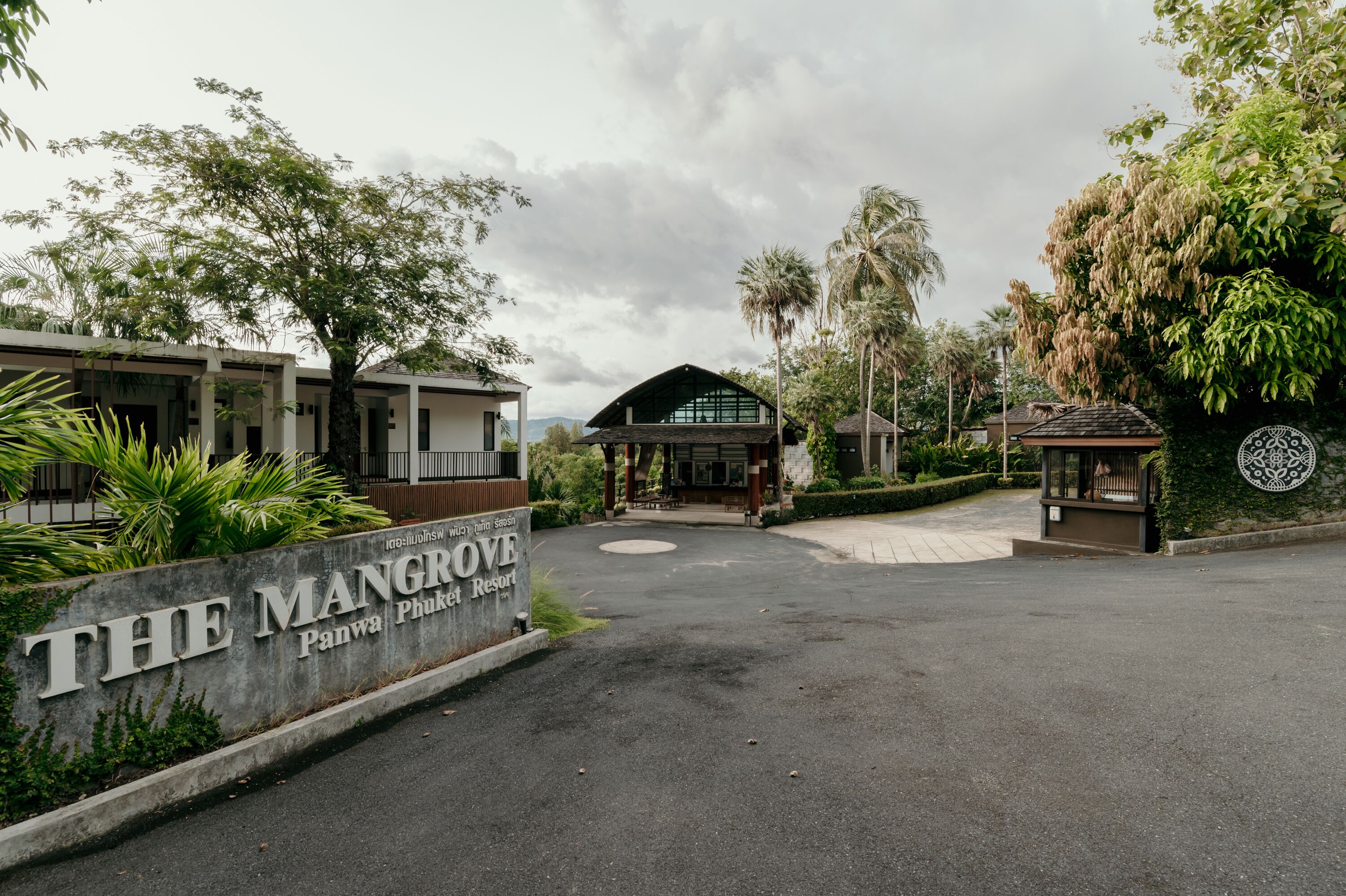 A resort entrance with a sign reading "The Mangrove Panwa Phuket Resort".