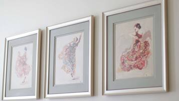Three framed artworks on a wall.