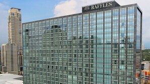 A modern building with the name "RAFFLES" on the top. It features a large glass facade and a rooftop pool area. - Raffles Makati (Makati)