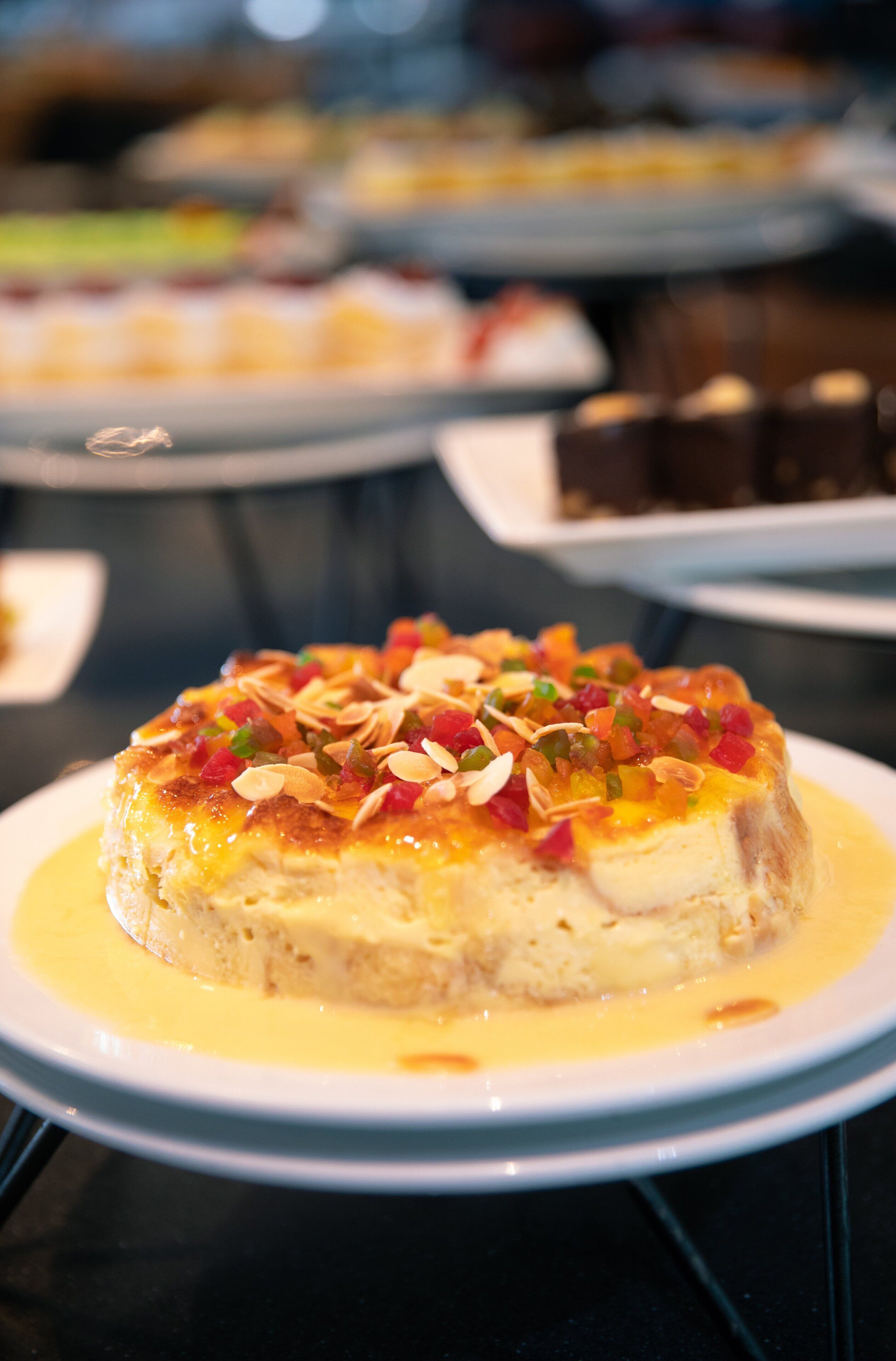 A dessert on a plate with a creamy sauce and toppings.