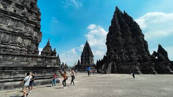 A temple complex with multiple stone structures and a paved walkway.