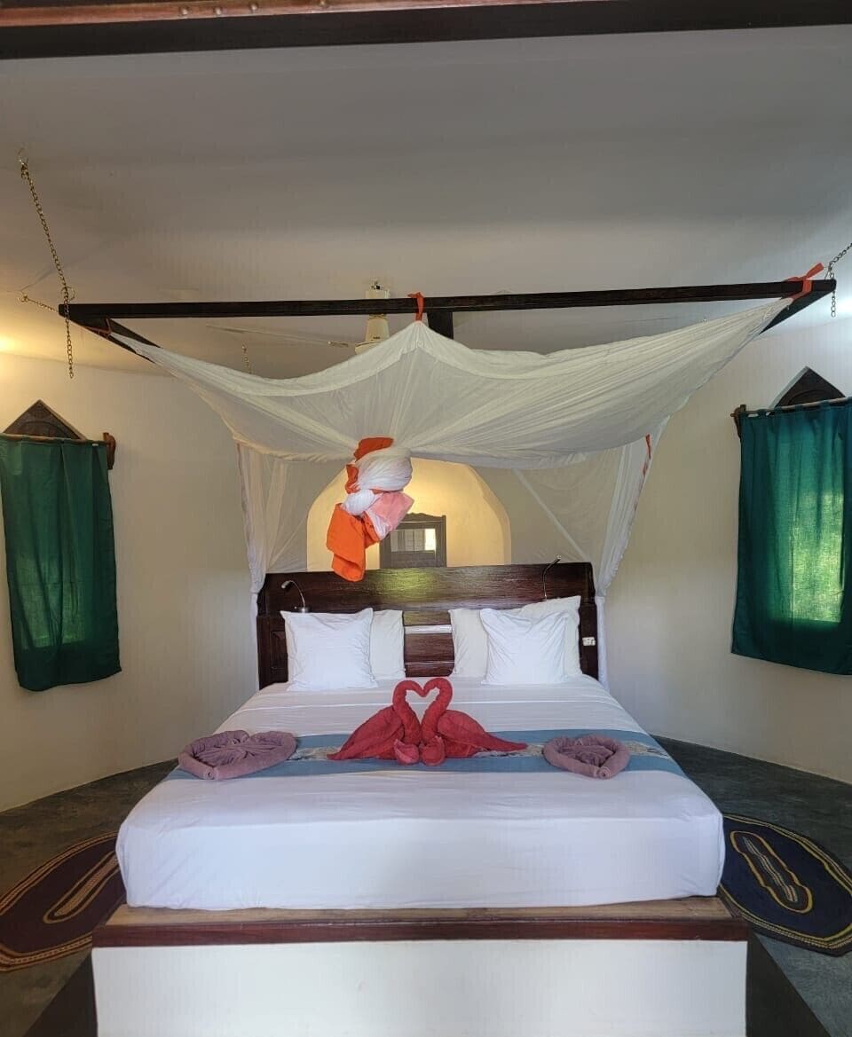 Family Room | In-room safe, individually decorated, bed sheets