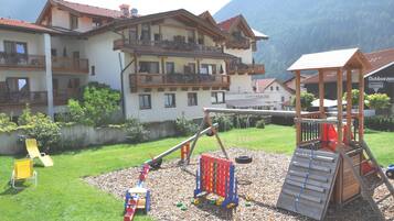 Kids can play on the slide, climbing wall, and play structures in the adjacent playground.