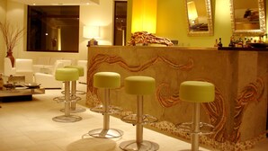 A modern hotel lobby with a reception desk, bar area, and seating. - KoKo Hotel Milano Marittima (Ravenna)
