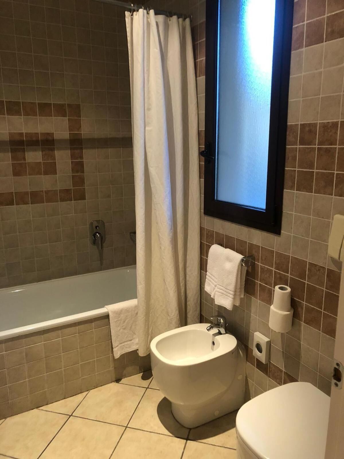 A bathroom with a bathtub, a sink, and a toilet.