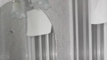 A bathroom with a white sink, a mirror, and a shower curtain.
