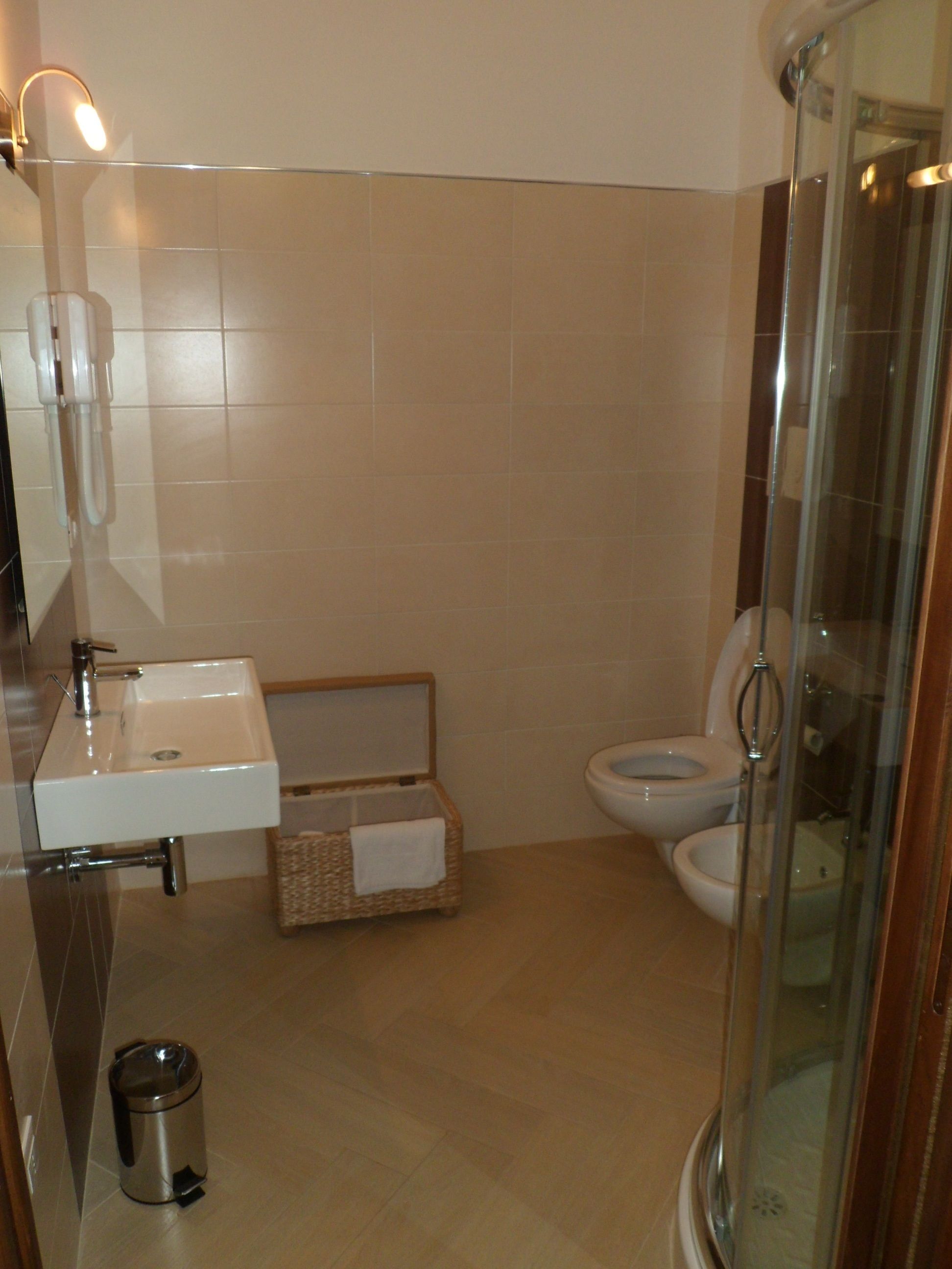 A bathroom with a sink, toilet, and shower.