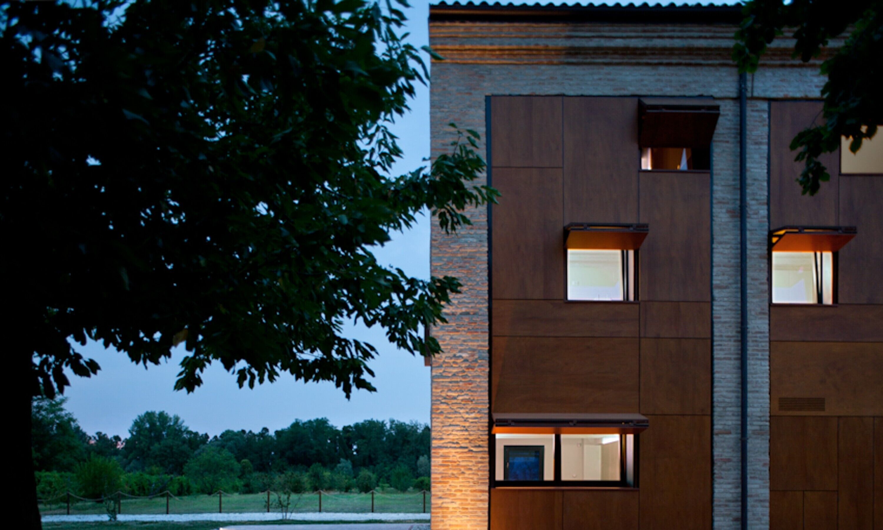 A modern building with a brick facade and multiple windows.