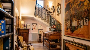 A staircase leading to a loft area with a wooden desk, books, and a chair. - Al Battistero Luxury Suite (Ravenna)