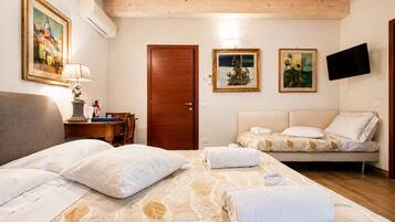 Deluxe Triple Room, 1 Bedroom | 1 bedroom, premium bedding, minibar, individually furnished