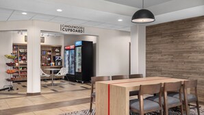 A modern kitchenette with a coffee machine, a refrigerator, and a microwave. - Candlewood Suites Alexandria by IHG (Alexandria)
