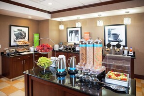 A buffet setup with various food items and beverages.