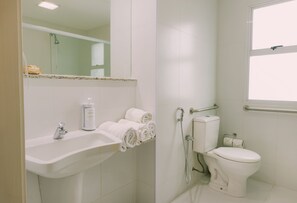 A bathroom with a sink, toilet, and shower.