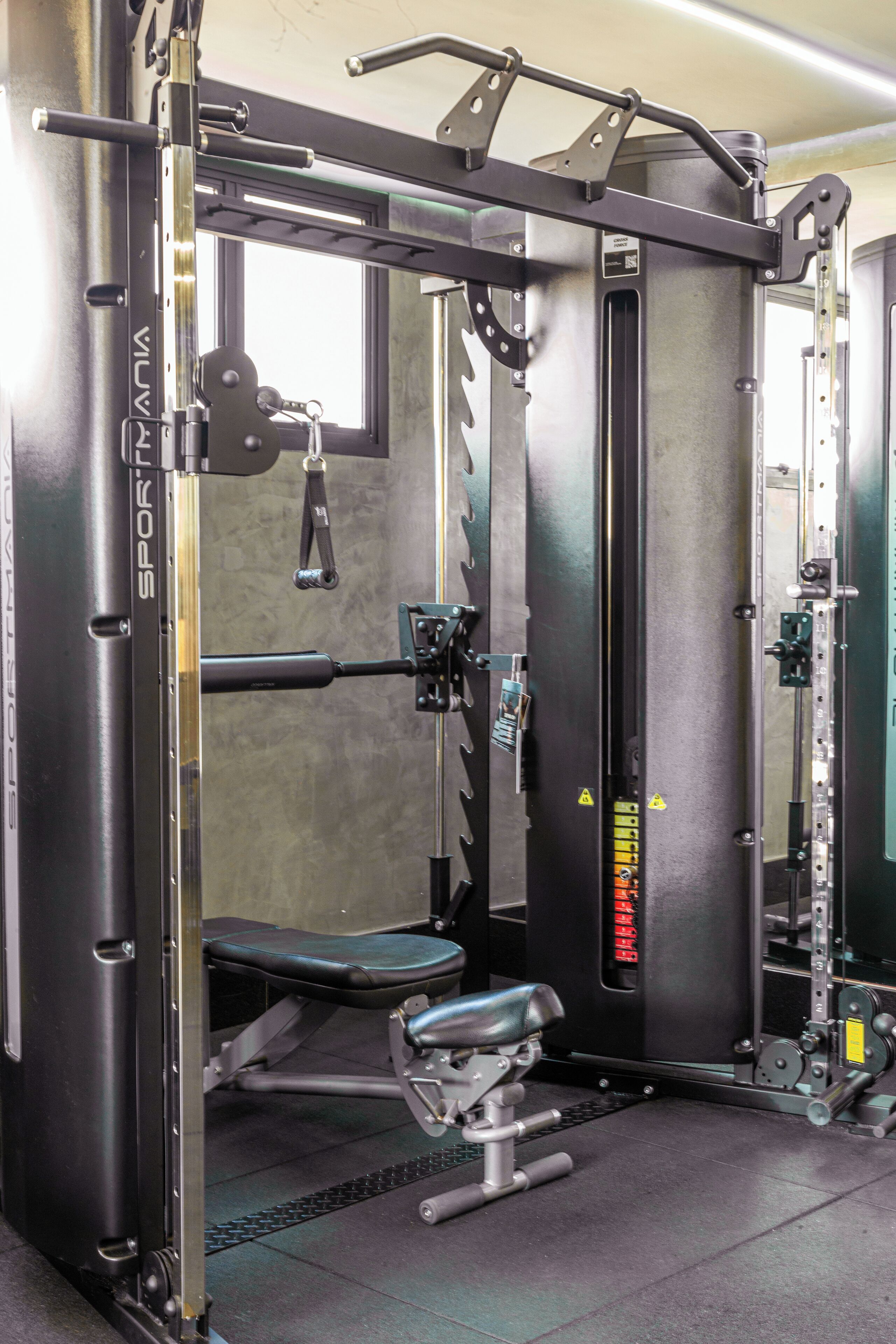 A gym with a squat rack, bench press, and various weight machines.